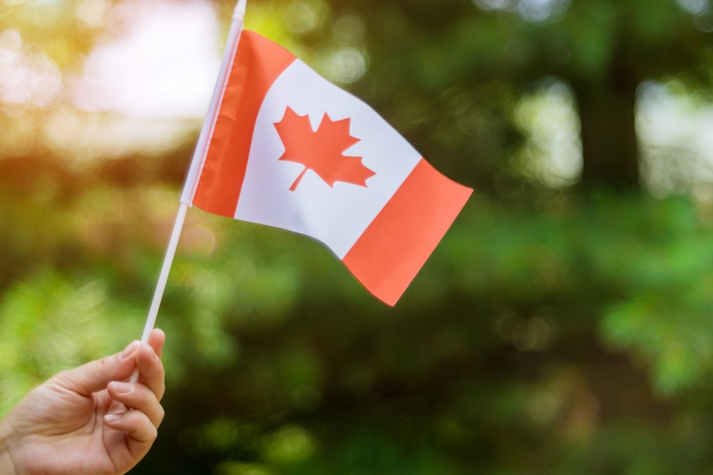 a woman is holding Canadian flag