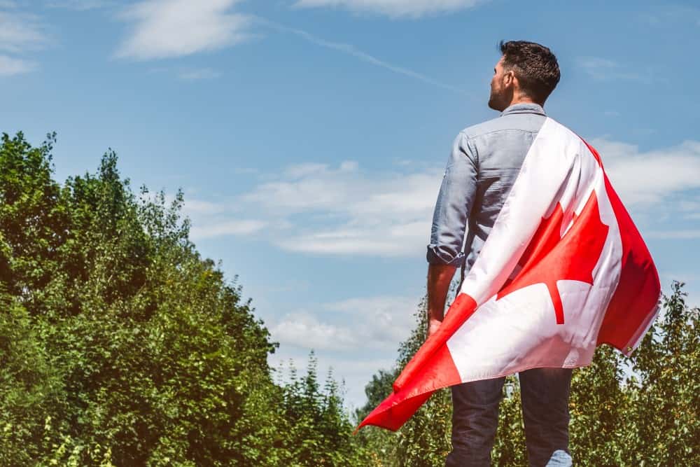 man holding Canadian flag